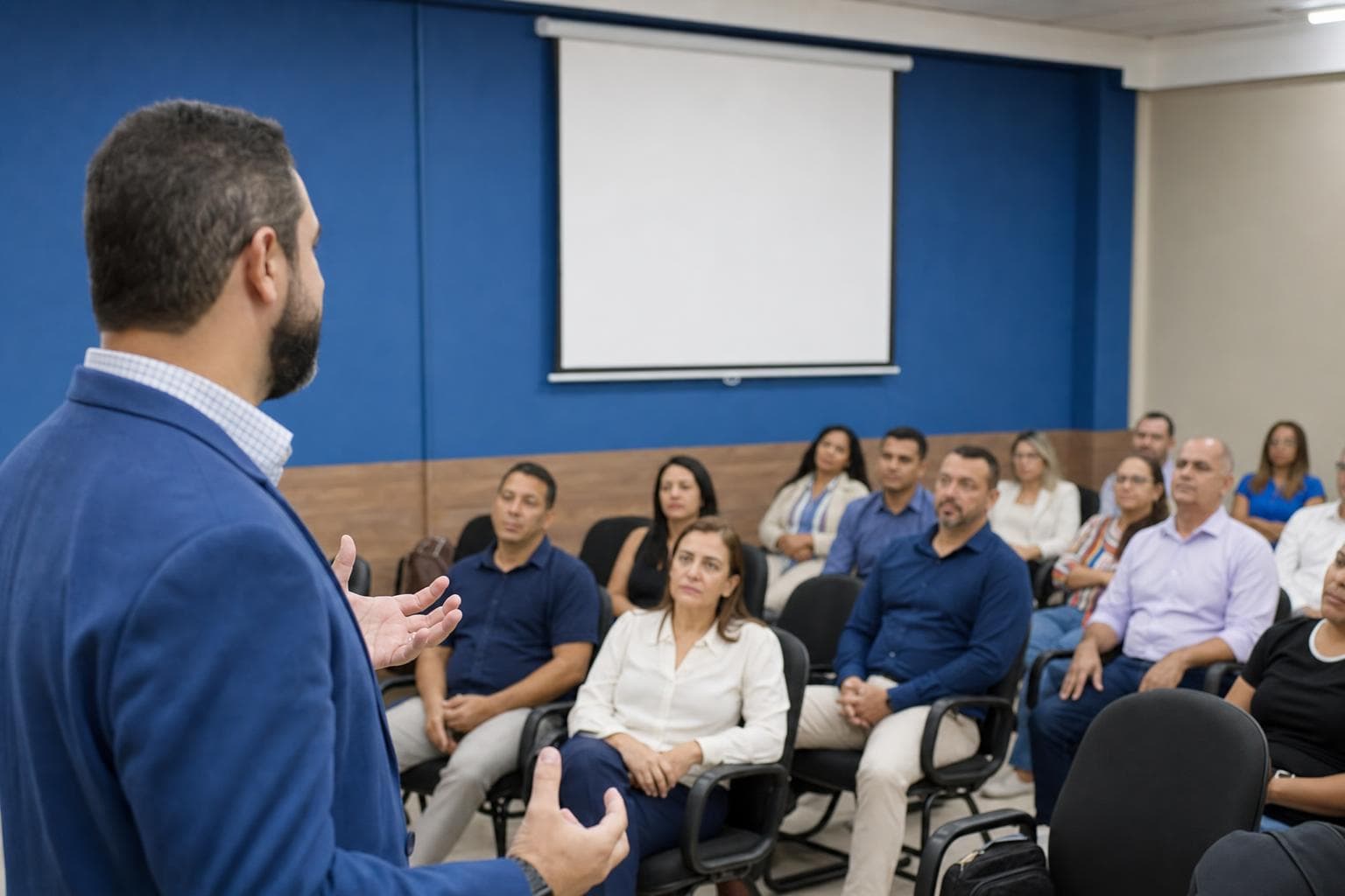 Palestrante apresentando para empresários em um pequeno auditório de associação comercial