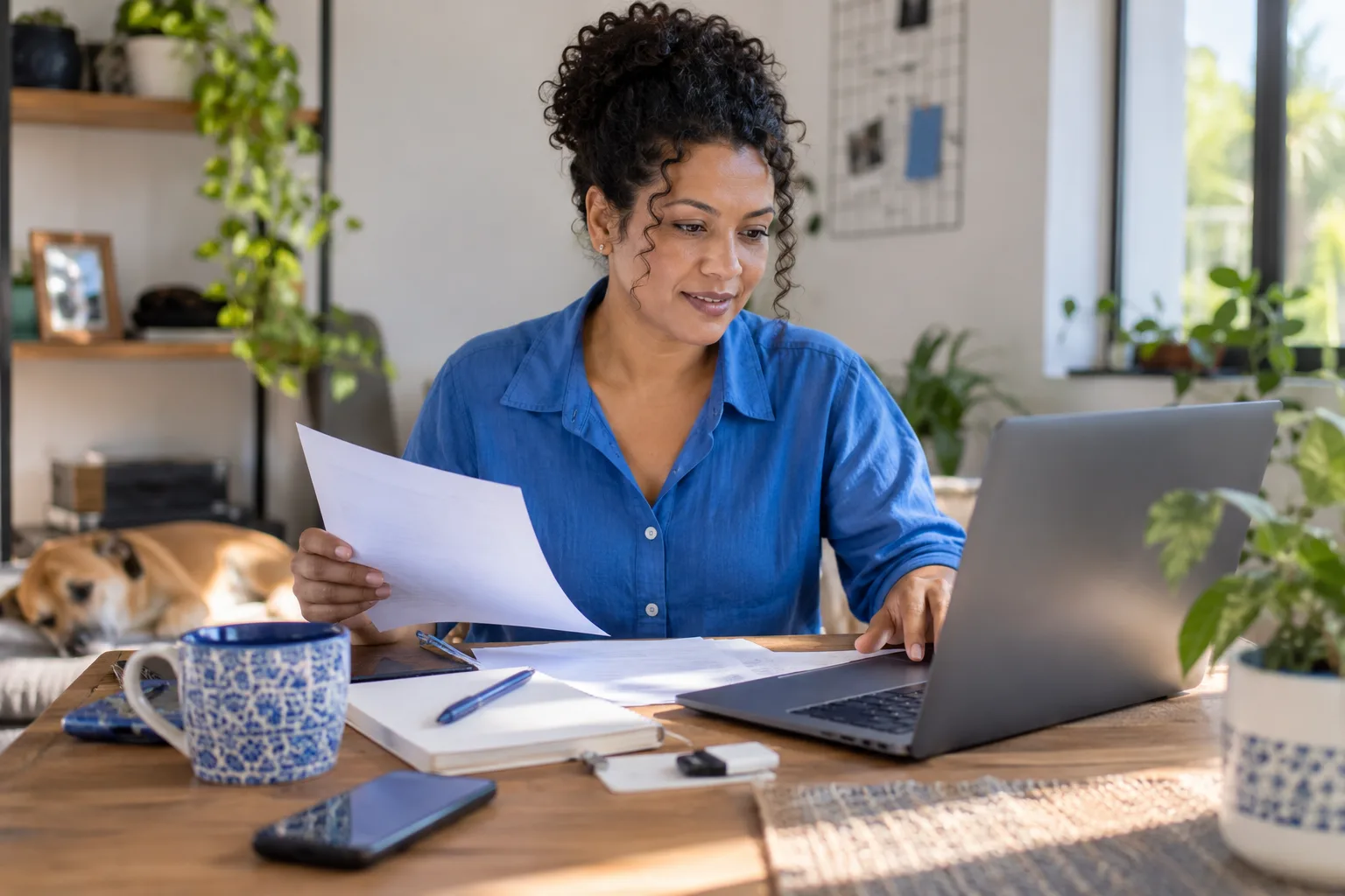 Empreendedora emite nota fiscal no notebook no escritório de casa